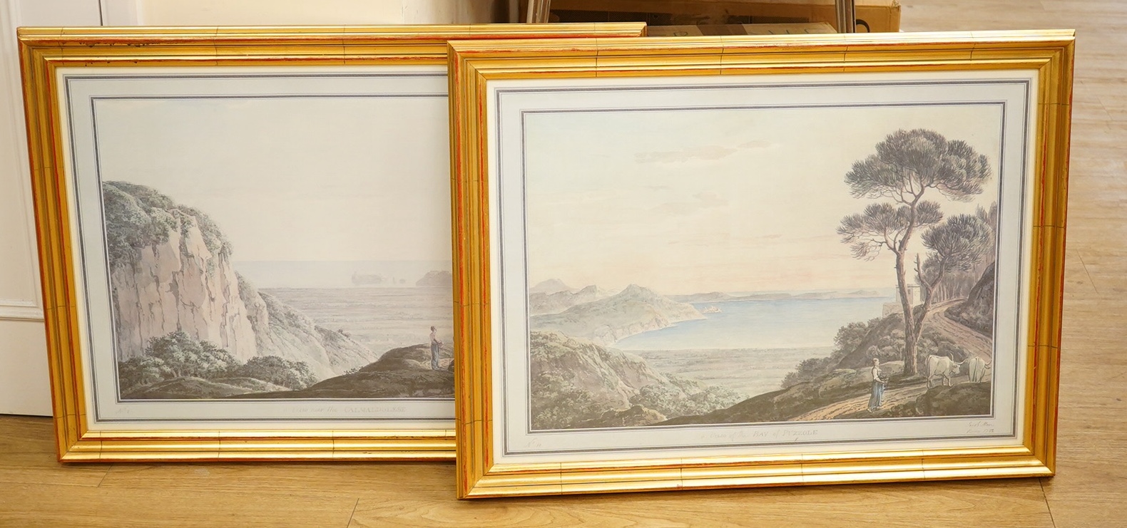 A pair of decorative prints comprising a ‘View of the Bay of Puzzole’ and ‘View near the Calmaldolese’, 48 x 68cm, gilt framed. Condition - good